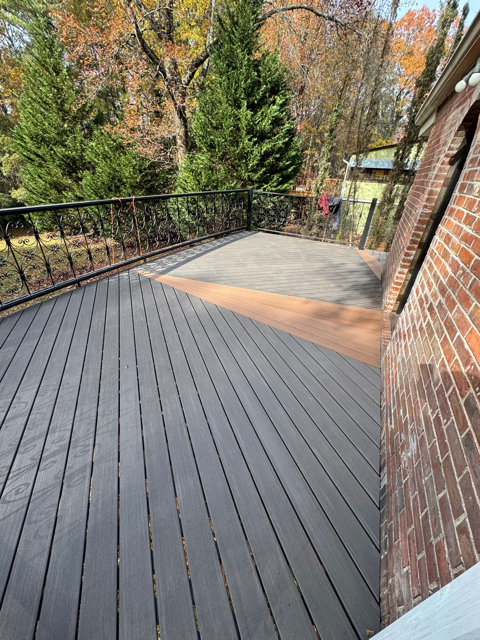 Two-tone composite deck with ornamental iron railing